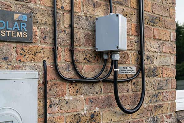 An example of a drip loop in a wire before it enters a junction box